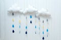 Weather symbols. Handmade room decoration clouds with rain drops