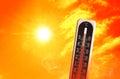 Weather thermometer with high temperature outdoors on hot sunny day. Heat stroke warning