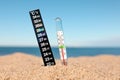 Weather thermometers in sand near sea, closeup