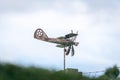 Weather vane in form of an old rusty biplane, at a side-view, with propellers not moving Royalty Free Stock Photo