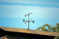 Weather Vane on Rusted Roof