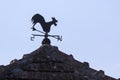 A weather vane or wind vane, weathercock on top of a building in a rural area Royalty Free Stock Photo