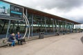 Exterior of motorway freeway services rest area showing building and outside seating area with people Royalty Free Stock Photo