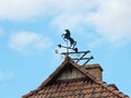 Weathercock on roof top, Latvia