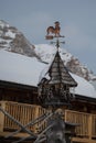 Weathercock, Weather Vane Wind Direction Decoration on Roof with Fresh Snow Royalty Free Stock Photo