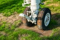 Weathered aviation landing gear rusting in a field showing signs of neglect