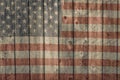 Weathered barn siding with faded painted american flag