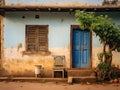 A weathered blue door set in a rustic wall with peeling paint. Concept of charm of simple, rural architecture. Royalty Free Stock Photo