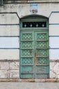 Weathered blue-green door in Cuenca, Ecuador