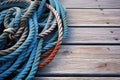 weathered boat ropes coiled on dock planks