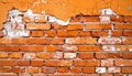 an orange brick wall with peeling paint Royalty Free Stock Photo