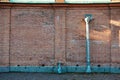 Weathered brick wall with a rusty metal drainpipe Royalty Free Stock Photo