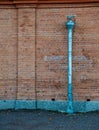 Weathered brick wall with a rusty metal drainpipe Royalty Free Stock Photo
