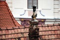 Weathered brown sloped clay shingle roof closeup. old brick chimney and concrete stack Royalty Free Stock Photo