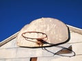 Weathered building and basketball hoop