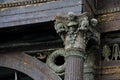 weathered carved support column of a ruined building