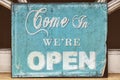 Weathered come in we're open sign Royalty Free Stock Photo