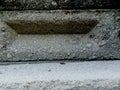 weathered concrete surface, showcasing the rough texture, cracks, and shadows created by its uneven surface Royalty Free Stock Photo