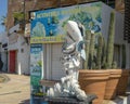 Weathered cool shark statue and large pots with cacti along the dock in Cabo San Lucas.