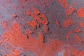 Weathered cracked red color paint on rustic wooden crooked panel