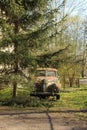 Weathered and damaged car stand on a roadside. Rusty cab forgotten for decades