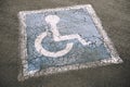 Weathered Disabled Sign in Parking Lot Royalty Free Stock Photo