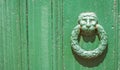 Weathered door knocker to cemetery crypt