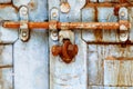 A weathered door locked by nut and bolt Royalty Free Stock Photo