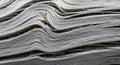 Weathered driftwood with smooth, undulating grooves forms wavelike patterns. The surface displays a Royalty Free Stock Photo