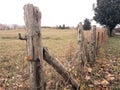 Weathered gate post and barbed wire fence Royalty Free Stock Photo