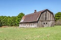 Weathered Gray Barn with Rusty Metal Roof Royalty Free Stock Photo