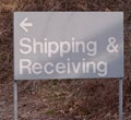 A metal sign stating `Shipping & Receiving`