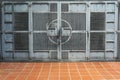 Weathered gray steel gate across an abandoned industrial site