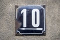 Weathered metal enameled plate of street address number 10