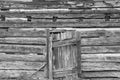 Weathered grungy old log cabin wall with old wooden door background wallpaper Royalty Free Stock Photo