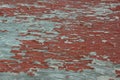 Weathered grungy peeling red paint on old grey plywood Royalty Free Stock Photo