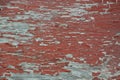 Weathered grungy peeling red paint on old grey plywood Royalty Free Stock Photo
