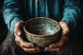 Weathered hands, empty bowl on wood backdrop, evoke the harshness of hunger Royalty Free Stock Photo