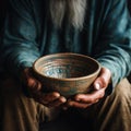 Weathered hands, empty bowl on wood backdrop, evoke the harshness of hunger