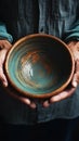 Weathered hands, empty bowl on wood backdrop, evoke the harshness of hunger Royalty Free Stock Photo