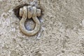 Weathered iron eyelet to fasten ships Royalty Free Stock Photo