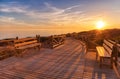 Weathered lumber path leading to calm sea during beautiful sunset Royalty Free Stock Photo