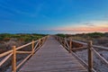 Weathered lumber path leading to calm sea during beautiful sunset Royalty Free Stock Photo