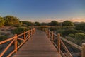 Weathered lumber path leading to calm sea during beautiful sunset Royalty Free Stock Photo