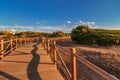 Weathered lumber path leading to calm sea during beautiful sunset Royalty Free Stock Photo