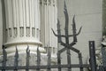 Weathered metal post finials Trident metal fence for protection against chimeras and evil power. Royalty Free Stock Photo