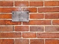 Weathered metal sign on a brick wall Royalty Free Stock Photo
