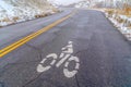 Weathered mountain road with bicycle lane sign Royalty Free Stock Photo