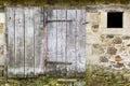 Weathered Old Barn Door and Stone Wall Royalty Free Stock Photo