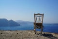 A weathered old chair with an amazing view in Santorini Royalty Free Stock Photo